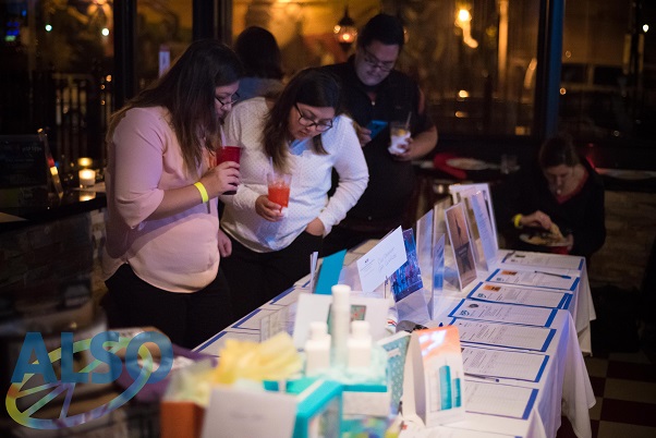 Benefit attendees looking at silent auction items on tables